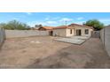 A spacious backyard with dirt landscaping and a newly poured concrete patio area, perfect for outdoor entertaining at 6434 W Riva Rd, Phoenix, AZ 85043