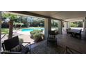 Comfortable patio space with outdoor seating overlooking the pool and garden area for relaxing and entertaining at 6911 E Thunderbird Rd, Scottsdale, AZ 85254