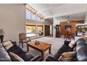Living room with large windows and a dining room in the background at 6931 E Pershing Ave, Scottsdale, AZ 85254