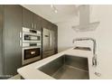 Close-up of a modern kitchen with stainless steel appliances, gas cooktop, and a sleek design at 7120 E Kierland Blvd # 316, Scottsdale, AZ 85254