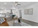 Open concept living and kitchen area with hardwood floors, modern lighting and neutral decor at 8020 E Thomas Rd # 313, Scottsdale, AZ 85251
