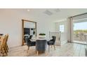 Cozy dining area with a round table, plush chairs, and abundant natural light at 8149 E Petunia Ave # 1060, Mesa, AZ 85212
