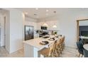 Modern kitchen features white cabinets, stainless steel appliances, and an island with seating at 8149 E Petunia Ave # 1060, Mesa, AZ 85212