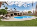 Private backyard oasis with a refreshing pool, lush landscaping, covered patio, and lounging area at 8713 E Citrus Way, Scottsdale, AZ 85250