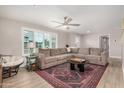 Cozy living room showcasing ample natural light, a ceiling fan, and a comfortable, oversized sectional sofa at 8713 E Citrus Way, Scottsdale, AZ 85250