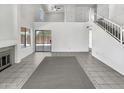 Spacious living area featuring tile floors, a fireplace, and access to the backyard at 8831 N 63Rd Dr, Glendale, AZ 85302