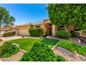 Inviting home with mature landscaping, a green lawn, a brick-lined garden, and secure front door at 941 N Benson Ln, Chandler, AZ 85224