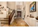 Inviting foyer featuring tile floors, a staircase, and double front doors at 11124 N 138Th Way, Scottsdale, AZ 85259