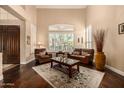 Bright living room with hardwood floors, shuttered windows, and comfortable leather seating at 11124 N 138Th Way, Scottsdale, AZ 85259