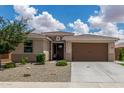 Inviting single-story home with a well-maintained lawn, two-car garage, and desert landscaping at 12289 E Ballentine Rd, Gold Canyon, AZ 85118