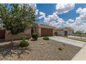 Well-maintained single-story home featuring desert landscaping, a two car garage, and neutral colors at 12289 E Ballentine Rd, Gold Canyon, AZ 85118