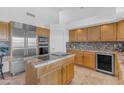 Spacious kitchen featuring stainless steel appliances, granite countertops, and custom cabinetry at 12605 E Kalil Dr, Scottsdale, AZ 85259