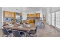 Open-concept kitchen with island, breakfast bar, stainless steel appliances, and adjacent dining area at 12605 E Kalil Dr, Scottsdale, AZ 85259