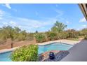 A refreshing pool is surrounded by lush landscaping and mature trees, creating a private oasis at 12605 E Kalil Dr, Scottsdale, AZ 85259