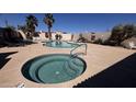 Resort-style community pool and spa area surrounded by palm trees and lounge chairs at 1440 N Idaho Rd # 1022, Apache Junction, AZ 85119