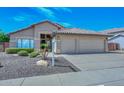Inviting single-story home with a two-car garage, well-maintained desert landscaping, and a tile roof at 1623 E Runion Dr, Phoenix, AZ 85024