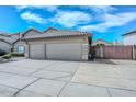 Spacious two-car garage with extended driveway and low-maintenance desert landscaping, providing ample parking at 1623 E Runion Dr, Phoenix, AZ 85024