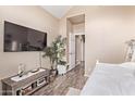 Bedroom with modern decor and wood-look tile flooring with a mounted flat screen tv at 1633 E Lakeside Dr # 156, Gilbert, AZ 85234