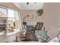 Living room with glass door to patio and a decorative fireplace with wicker-themed wall decor at 1633 E Lakeside Dr # 156, Gilbert, AZ 85234