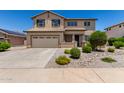 Two-story home with a two-car garage, tiled roof, desert landscaping, and covered entry at 16450 W Lilac St, Goodyear, AZ 85338