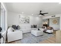 Bright living room with modern white furniture, accent pillows, and stylish decor at 1713 W Royal Palm Rd, Phoenix, AZ 85021