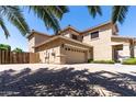 Spacious three-car garage with ample parking space and a well-kept driveway at 18432 W Port Royale Ln, Surprise, AZ 85388