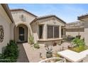 Inviting front porch and walkway featuring desert plants and a cozy outdoor seating area at 18634 N Paloma Ct, Surprise, AZ 85387