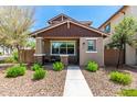Inviting home with desert landscaping, a covered porch, and a secure gated entry at 1882 S Jesse Pl, Chandler, AZ 85286