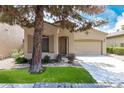 Well-kept home exterior with a tidy lawn and an attached two-car garage at 1887 W Periwinkle Way, Chandler, AZ 85248