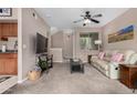 Open-concept living room boasts a comfortable sofa, TV, and seamless flow to the kitchen and staircase at 1920 E Bell Rd # 1189, Phoenix, AZ 85022