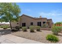 Landscaped exterior featuring desert landscaping with gravel, bushes, and small tree at 19530 N 84Th Ave, Peoria, AZ 85382