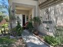 Inviting walkway up to the front door with lovely desert landscaping and decorative wall art at 21873 W Pima St, Buckeye, AZ 85326