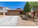 Charming single-story home featuring a two-car garage and desert landscaping at 2223 S Hughes Dr, Buckeye, AZ 85326