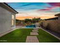 Beautiful backyard with artificial turf, paver walkway, and a serene pool at 2315 W Duane Ln, Phoenix, AZ 85085