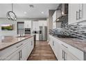 Modern kitchen featuring stainless steel appliances, a large island, and a stylish tile backsplash at 2315 W Duane Ln, Phoenix, AZ 85085