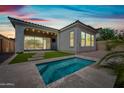 A backyard oasis featuring a sparkling pool, patio, and lush greenery under a vibrant sky at 2315 W Duane Ln, Phoenix, AZ 85085