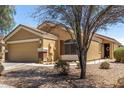 View of the home's facade, showcasing its neutral color palette and attached two-car garage at 23749 W Grove St, Buckeye, AZ 85326