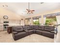 Open-concept living area with a ceiling fan, large windows, and tile flooring at 251 E Arabian Dr, Gilbert, AZ 85296