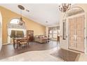 Inviting living space with high ceilings, elegant chandeliers, and tiled floors at 251 E Arabian Dr, Gilbert, AZ 85296