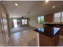 Kitchen view open to a living space with a sliding glass door to the outside at 26747 W Pontiac Dr, Buckeye, AZ 85396