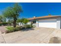Exterior view of home with well-maintained lawn, two-car garage and mature trees, providing curb appeal at 2908 N 54Th Dr, Phoenix, AZ 85031