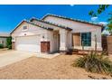 Single-story home featuring a two-car garage, desert landscaping, and covered entryway at 3006 W Matthew Dr, Phoenix, AZ 85027
