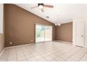 Open-concept living room with neutral tones, tile flooring, and sliding glass doors leading to outdoor space at 3006 W Matthew Dr, Phoenix, AZ 85027