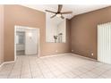 Inviting living room with tile flooring, neutral paint, and an open layout to a kitchen area at 3006 W Matthew Dr, Phoenix, AZ 85027
