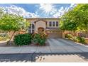 Charming two-story home with desert landscaping, a tile roof, and an attached two-car garage at 3025 N Desert Horizons Ln, Casa Grande, AZ 85122