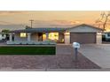 Charming single-story home featuring a quaint porch and a well-maintained front yard at 434 N 56Th St, Mesa, AZ 85205