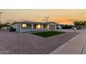 Cozy single-story home featuring a quaint front porch, a well-kept lawn and desert landscaping at 434 N 56Th St, Mesa, AZ 85205