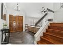 Welcoming foyer boasts hardwood floors, wooden staircase, double doors, and stylish decor at 438 E Larkspur Ln, Tempe, AZ 85288