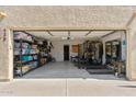 Spacious garage with an open door, featuring ample storage shelves and workout equipment at 438 E Larkspur Ln, Tempe, AZ 85288
