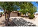 Charming home with a two-car garage and xeriscaped front yard for low-maintenance appeal at 5320 E Silverbell Rd, San Tan Valley, AZ 85143
